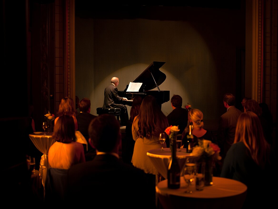  Live music performance inside Blue Note Napa with seated guests listening at tables in a softly lit historic venue.
