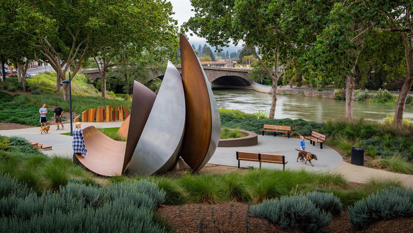 Public art sculpture along the downtown Napa ARTwalk beside the Napa River Trail with trees and walkways in the background.