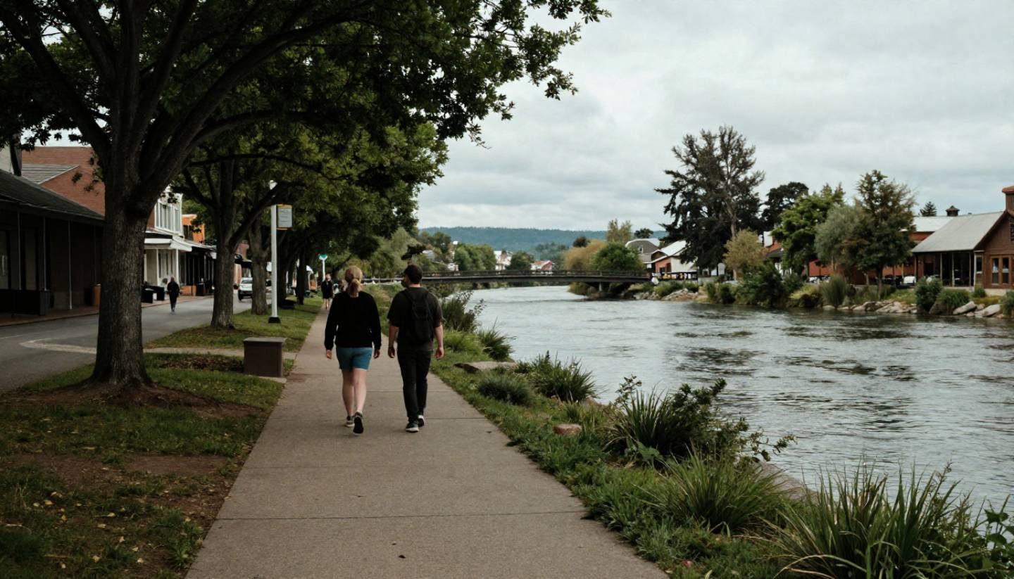Person walking along the Napa Riverfront near Downtown Napa on a quiet morning with trees and water alongside the path.
