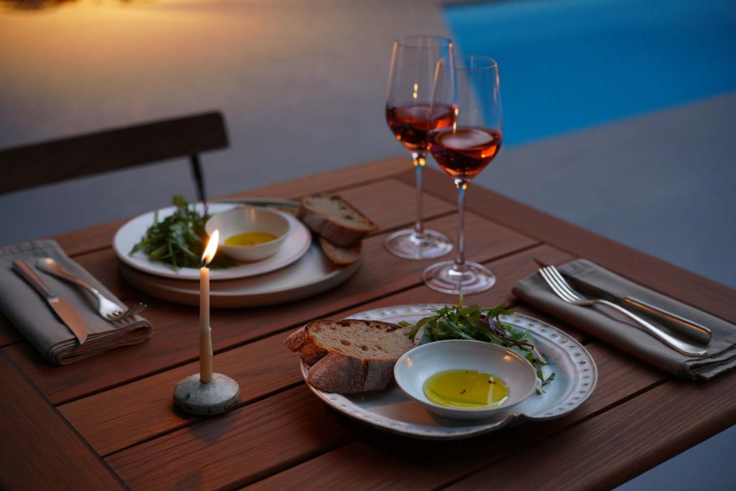  Early dinner table in Napa Valley with simple food, wine, and candlelight during a calm evening.
