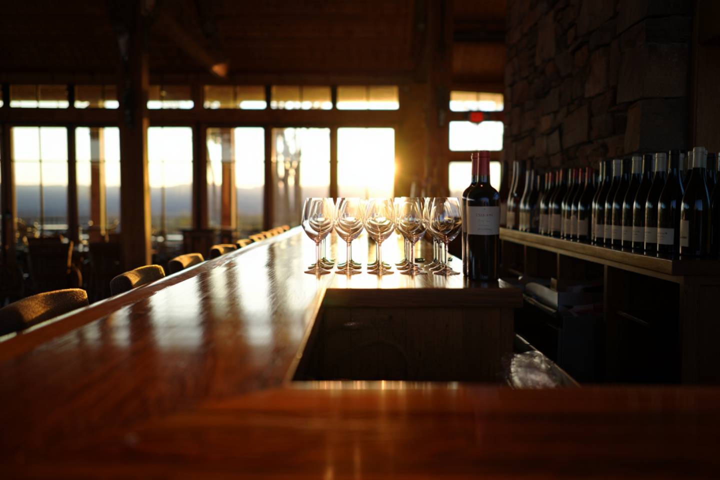Napa Valley tasting room in early morning light with empty glasses ready for the first appointment, illustrating a calm and unhurried winery experience.