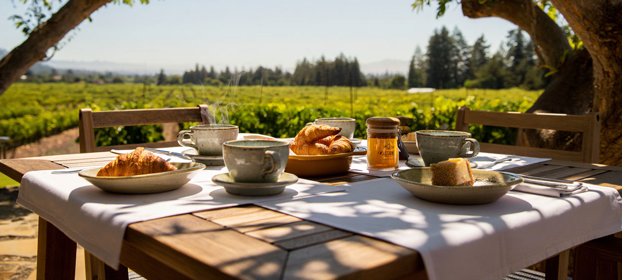 Garden breakfast at a boutique hotel in Napa Valley with coffee and pastries, reflecting the relaxed pace of a wine country morning.