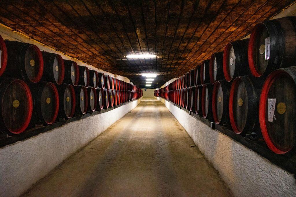 Winemaker pulling Cabernet from barrel during a Napa tasting.