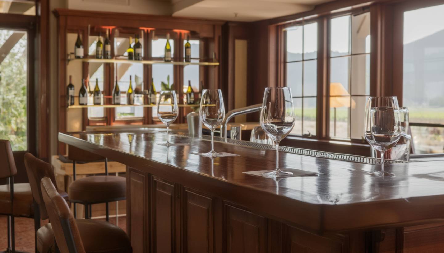 Napa Valley tasting lounge with open bar seating and wine glasses, illustrating a walk in friendly wine experience without reservations.