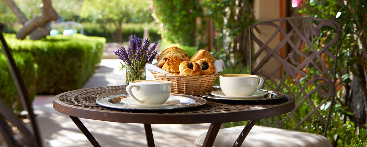 Stone garden path at a boutique Napa Valley hotel leading toward vineyard views, showing the intimate and walkable nature of small wine country inns.