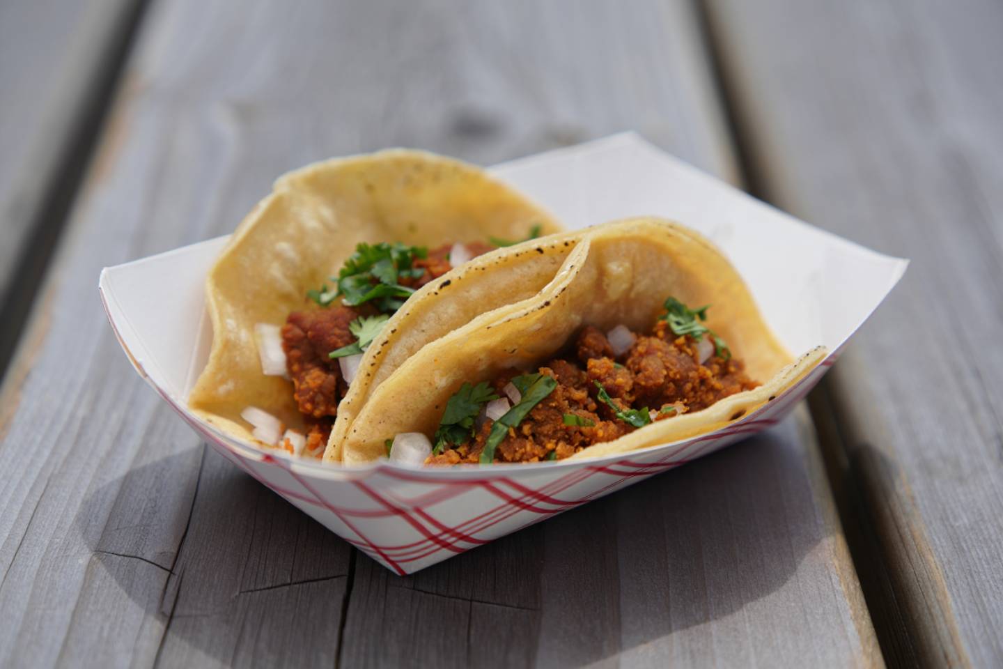 Casual meal served in paper trays on an outdoor picnic table in Napa Valley, highlighting informal local food between tastings.