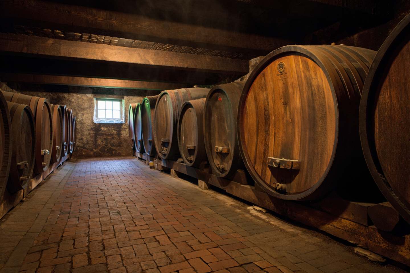 Interior of a historic Napa Valley building with stone walls and wooden stairs, highlighting age and craftsmanship.