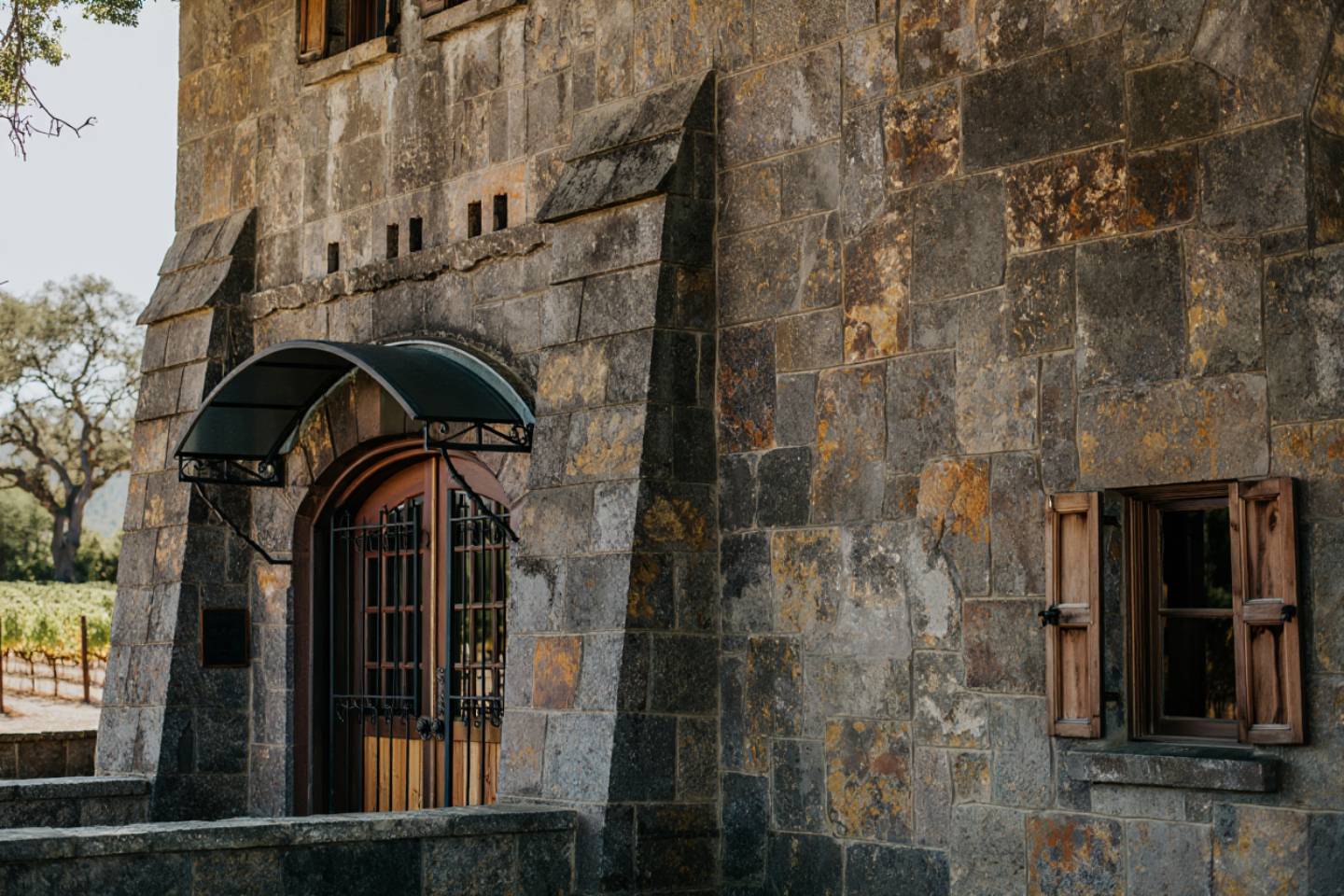 Historic stone inn in Napa Valley during early morning light, showing thick masonry walls and traditional architecture.