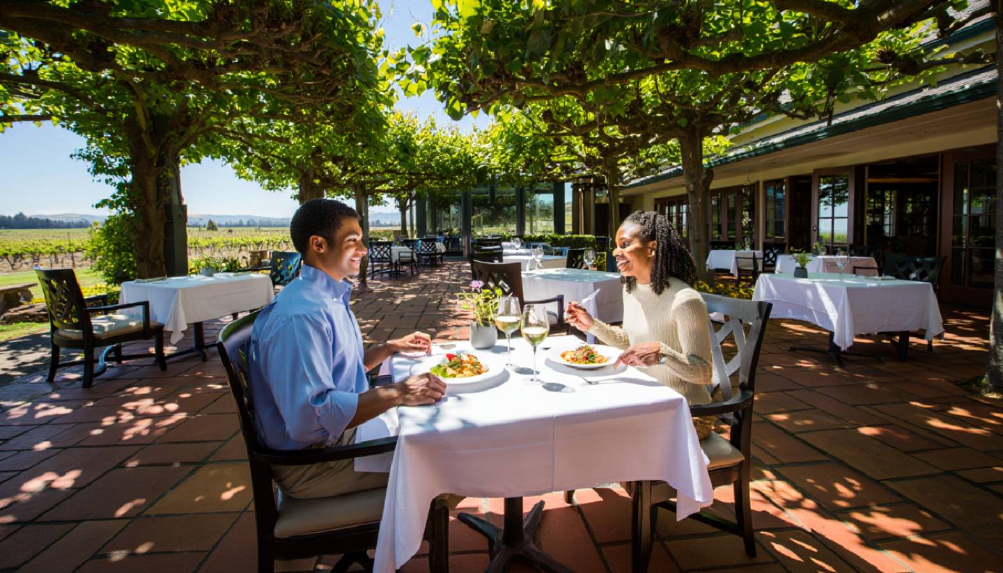 Outdoor lunch patio in Napa Valley during off peak hours, with minimal guests, natural light, and a relaxed, uncrowded dining atmosphere.
