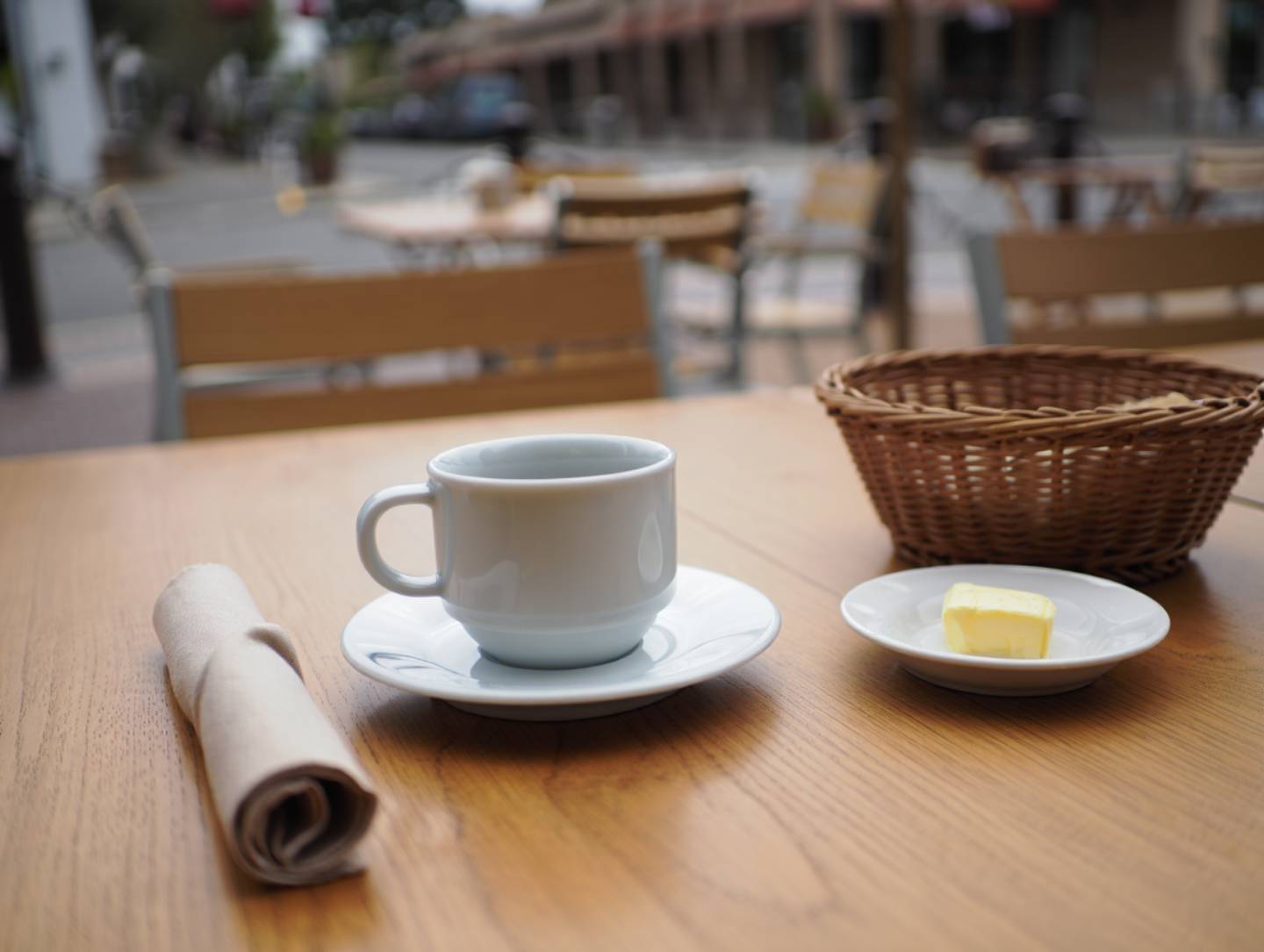 Ceramic cup of coffee on a café table in Napa Valley during a quiet morning, showing a slow breakfast and local coffee culture.