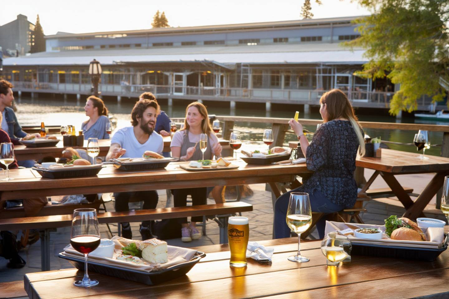 Shared tables at Oxbow Public Market in Napa Valley with casual food from local vendors, illustrating relaxed local dining culture.