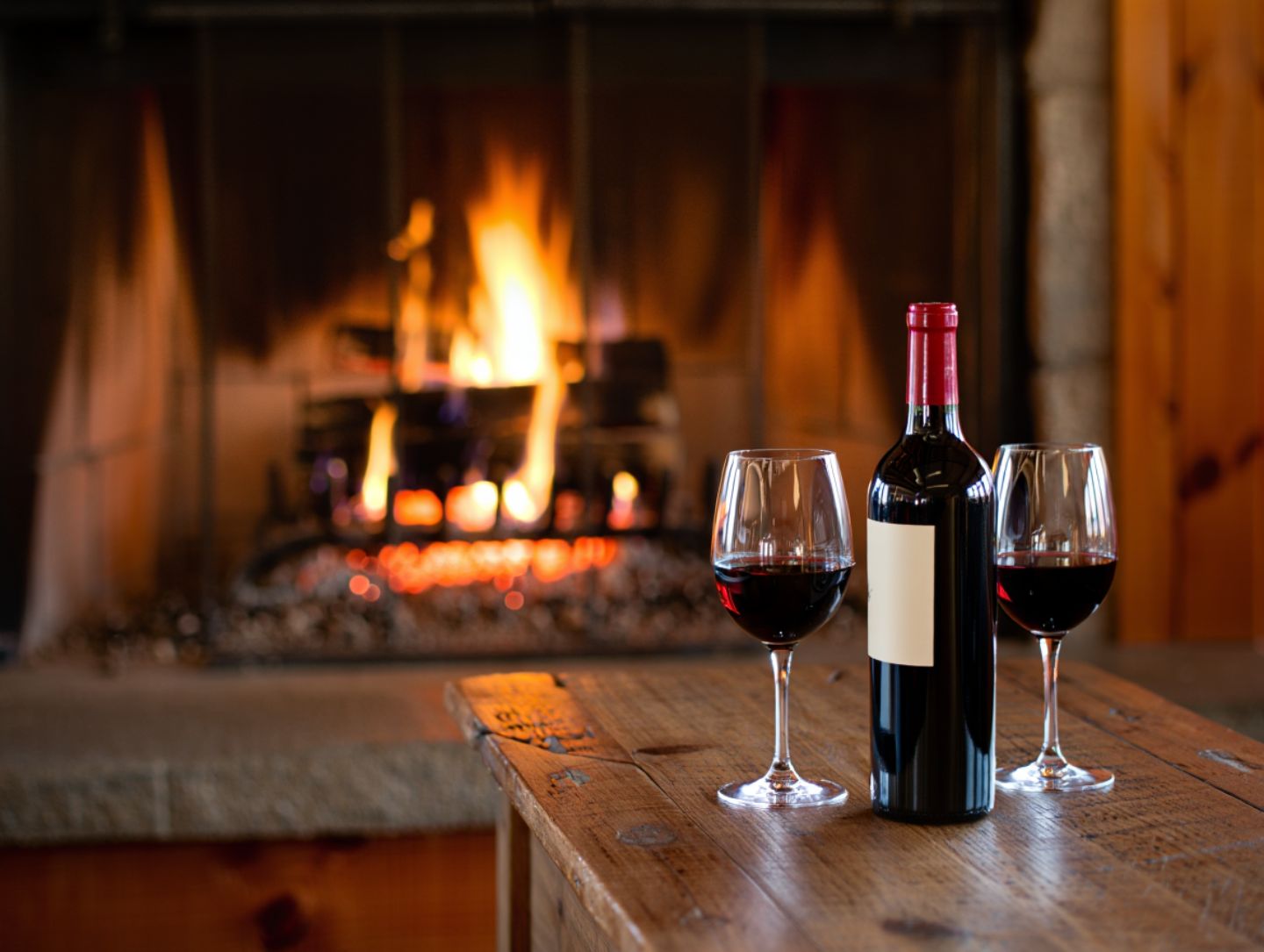 Indoor fireside wine tasting in Napa Valley during winter with warm lighting and a cozy atmosphere.