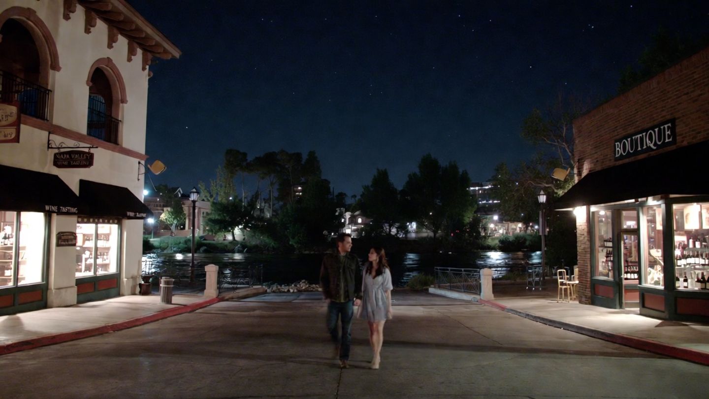 Couple walking through downtown Napa Valley at night after a live music performance, with softly lit buildings and a calm evening atmosphere.