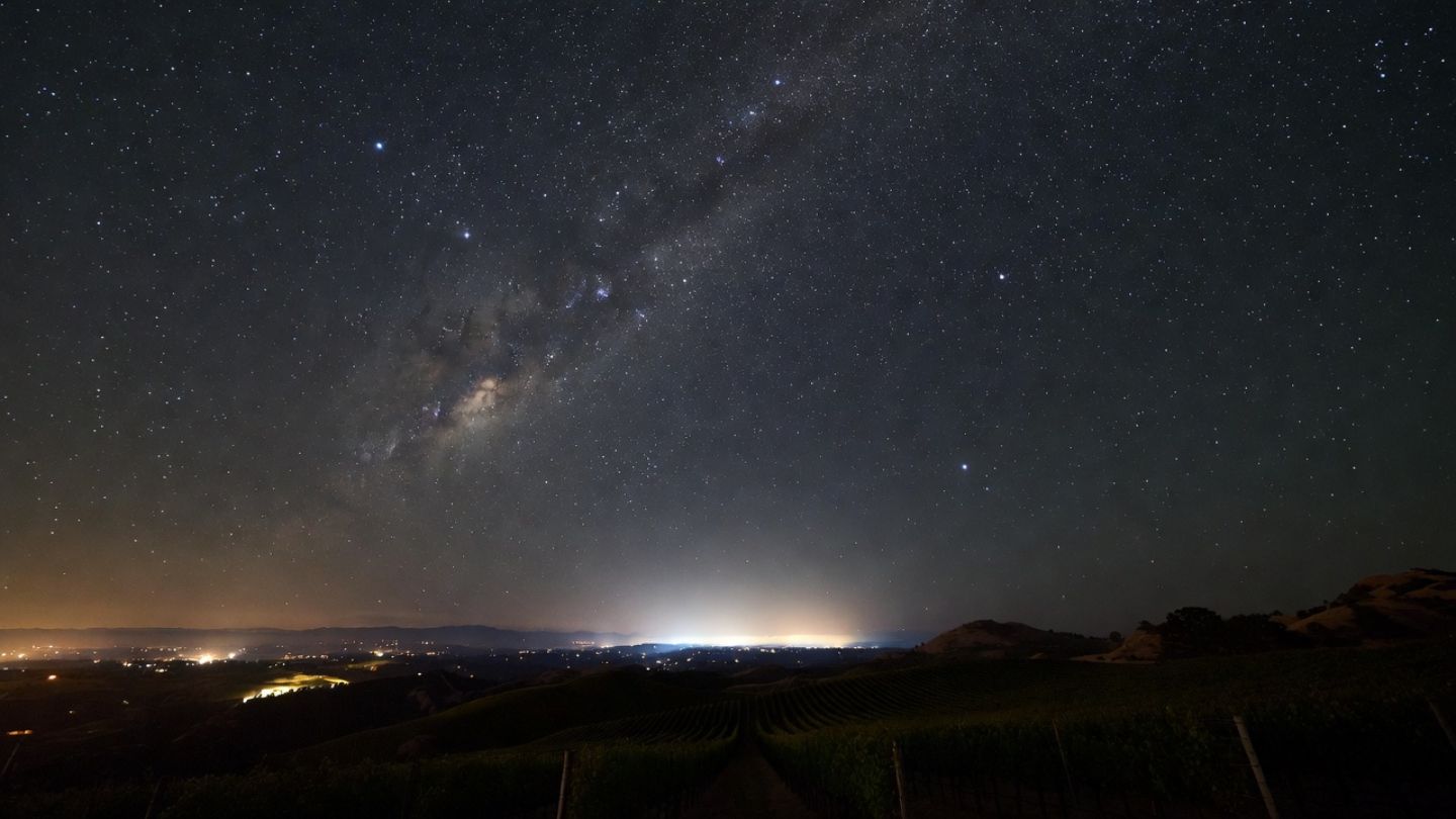 Milky Way visible over vineyard rows in the eastern hills of Napa Valley, showing a quiet stargazing location away from city lights.